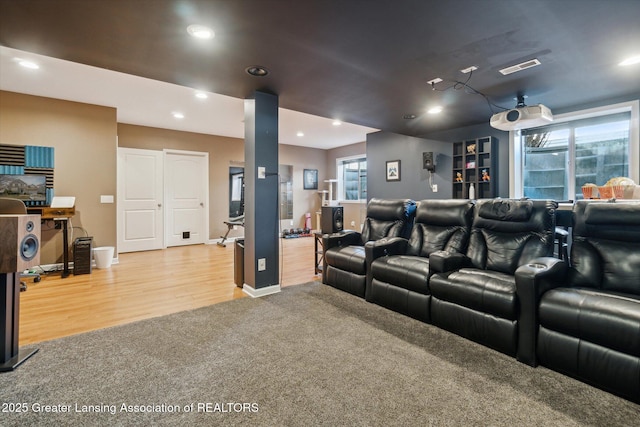 cinema room featuring recessed lighting, a healthy amount of sunlight, and wood finished floors