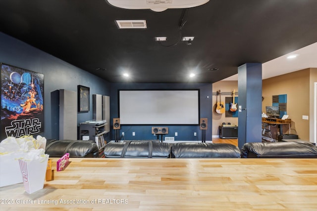 home theater room with recessed lighting, visible vents, and wood finished floors