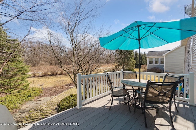 wooden terrace with outdoor dining area