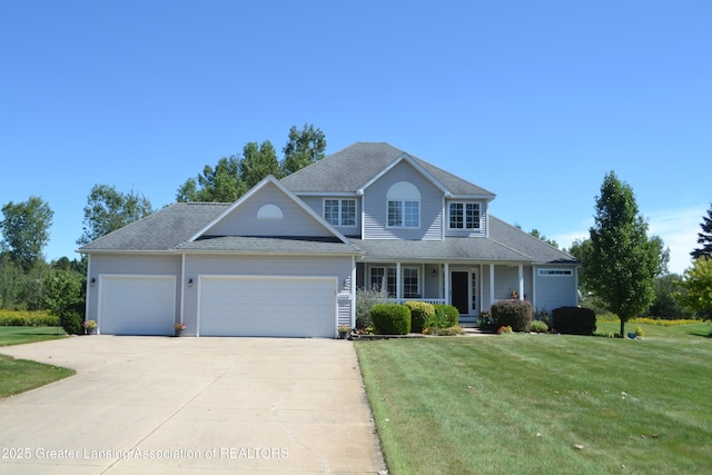 view of front of property featuring driveway, an attached garage, covered porch, and a front lawn