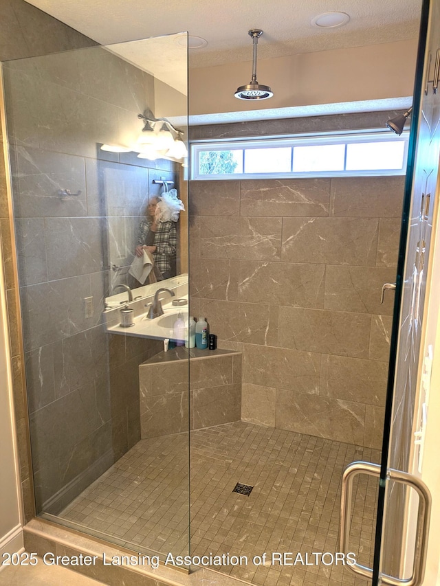 full bathroom featuring a stall shower and a wealth of natural light