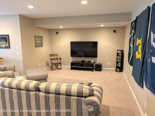 carpeted living area featuring recessed lighting and baseboards