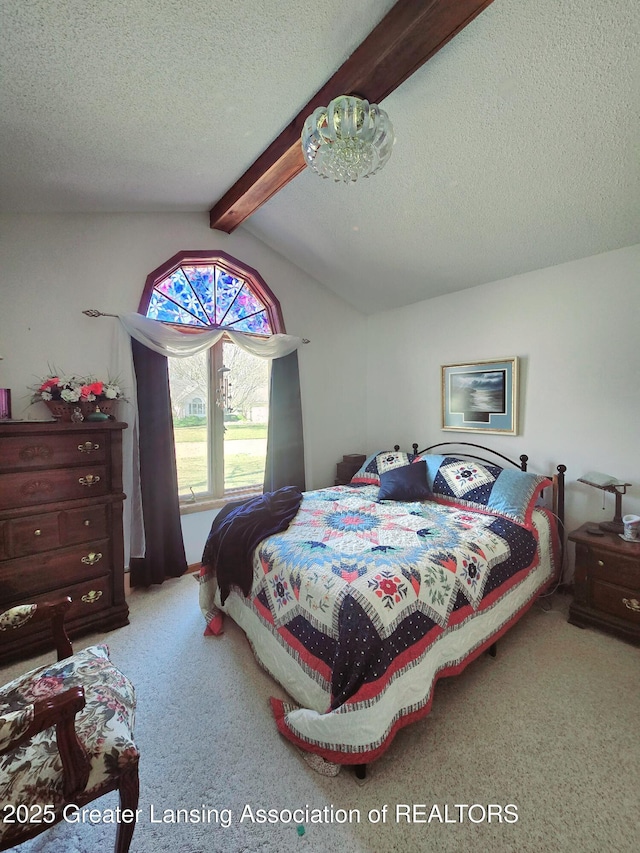 carpeted bedroom with a textured ceiling and vaulted ceiling with beams