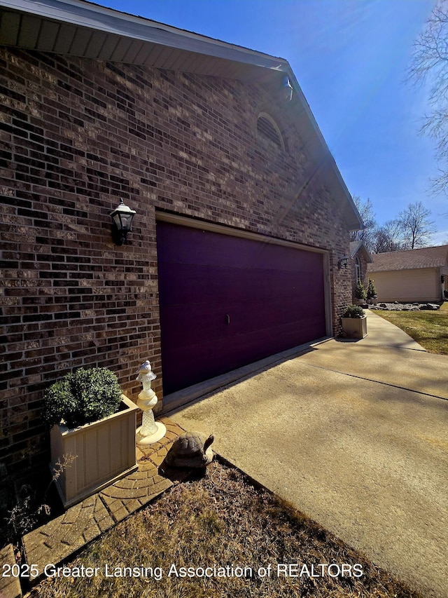 garage featuring concrete driveway