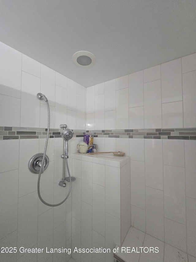 full bath featuring tiled shower