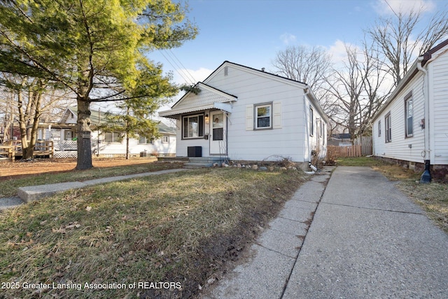 bungalow-style home featuring entry steps and fence