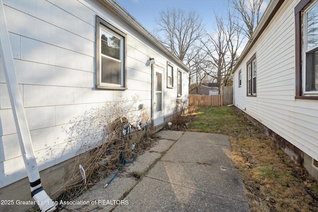 view of home's exterior featuring fence