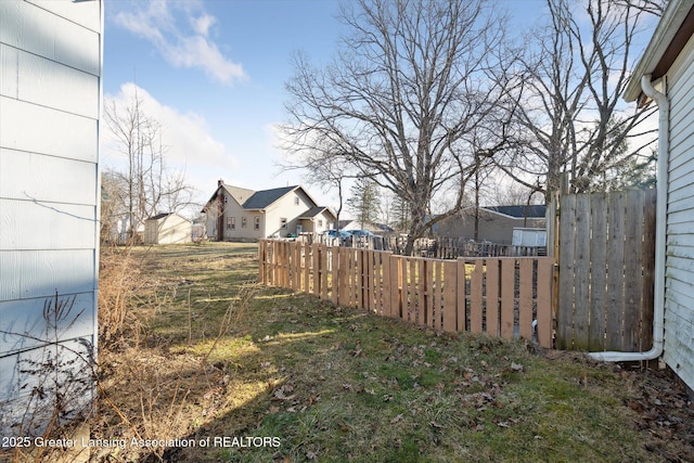 view of yard featuring a residential view and fence