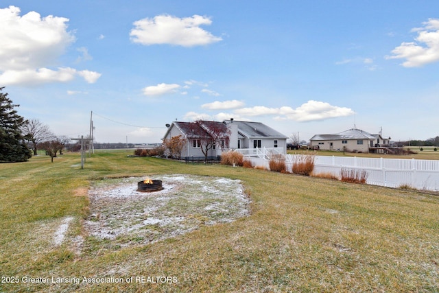 view of yard featuring a fire pit and fence