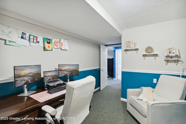 carpeted office with baseboards and a textured ceiling