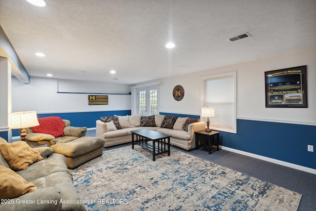 living room featuring baseboards, visible vents, recessed lighting, french doors, and a textured ceiling