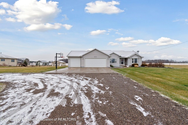 ranch-style home with a garage, concrete driveway, and a front lawn