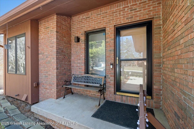 doorway to property with brick siding