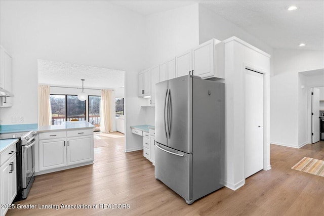 kitchen featuring white cabinetry, light wood-style floors, appliances with stainless steel finishes, and light countertops