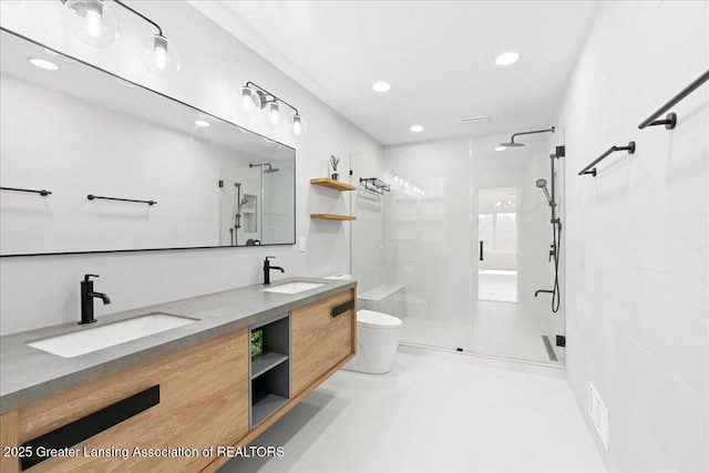 full bath with a shower stall, toilet, double vanity, and a sink