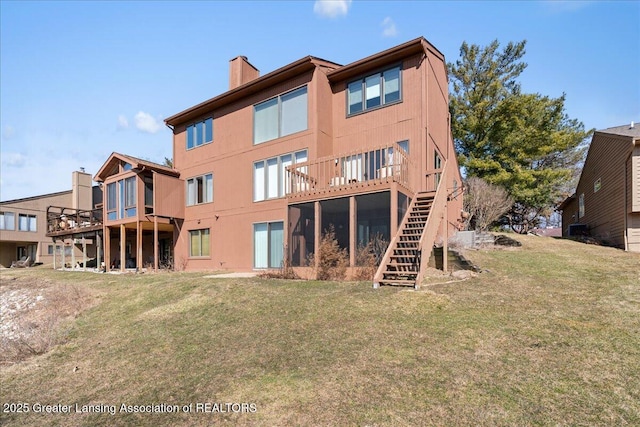 rear view of property featuring stairs, a yard, and a chimney