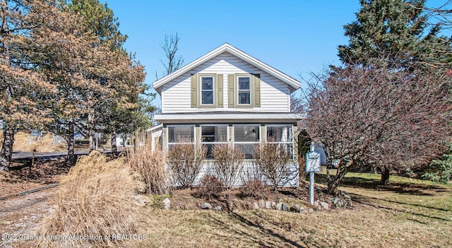 view of property exterior with a sunroom