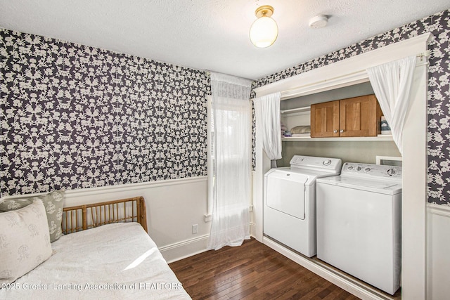 laundry area featuring baseboards, washer and dryer, dark wood-style floors, cabinet space, and a textured ceiling