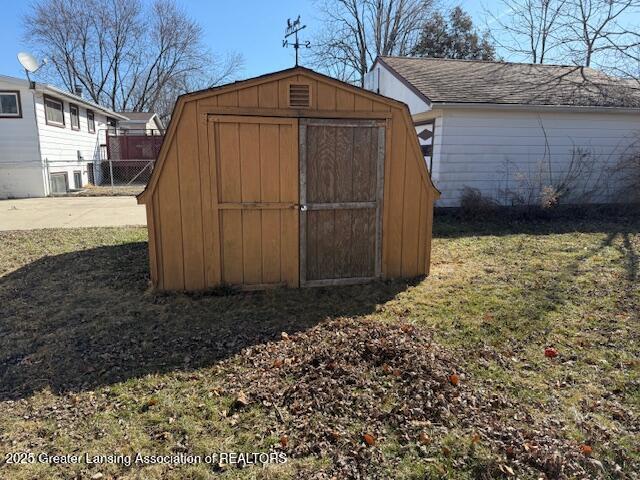 view of shed with fence