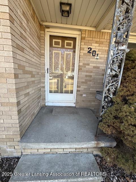 entrance to property with brick siding