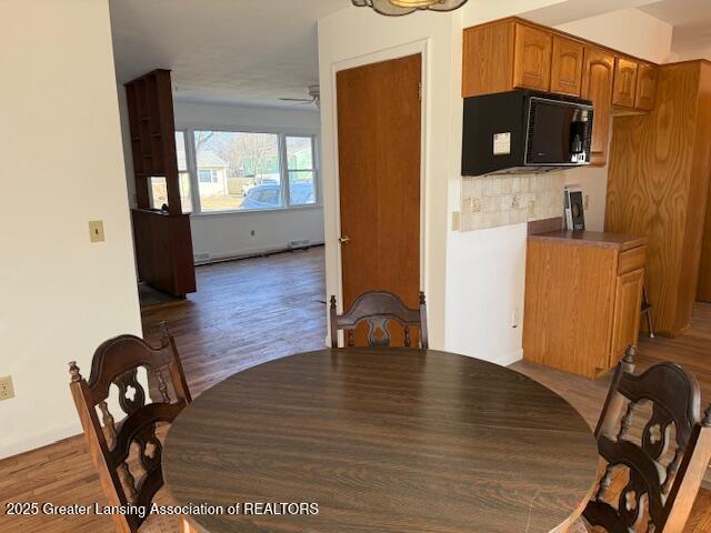 dining area featuring wood finished floors and a ceiling fan