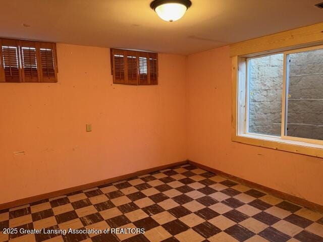 empty room featuring tile patterned floors and baseboards