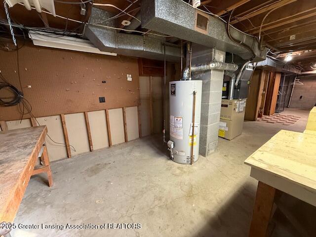 unfinished basement featuring heating unit and gas water heater