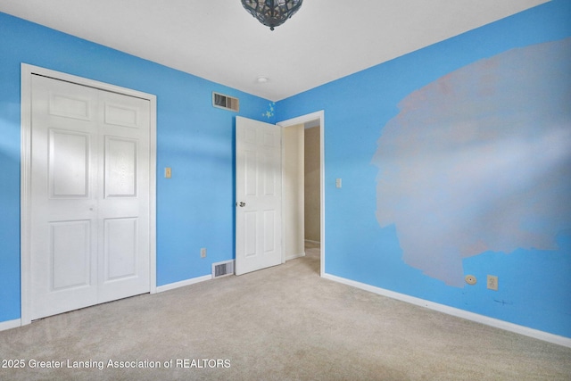 unfurnished bedroom featuring carpet flooring, baseboards, and visible vents