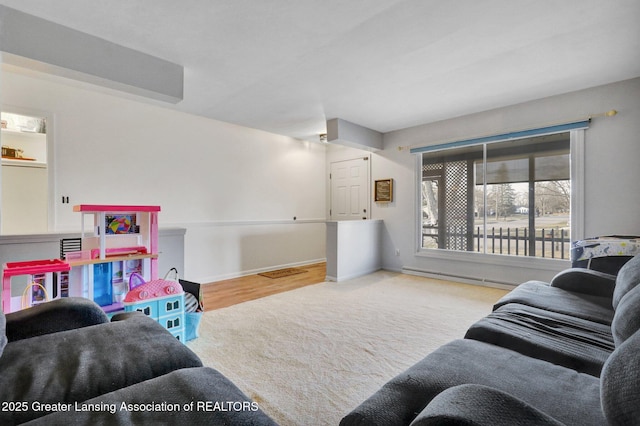 living area with carpet, baseboards, and a baseboard radiator