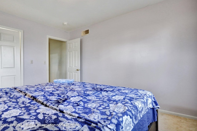 bedroom with visible vents, baseboards, and carpet