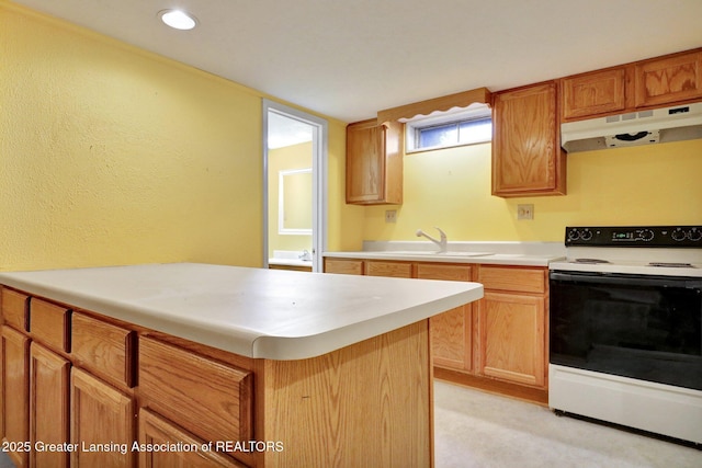 kitchen featuring under cabinet range hood, electric range, light countertops, and a sink