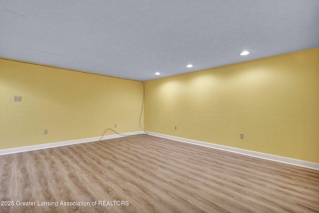 unfurnished room with recessed lighting, baseboards, and light wood finished floors