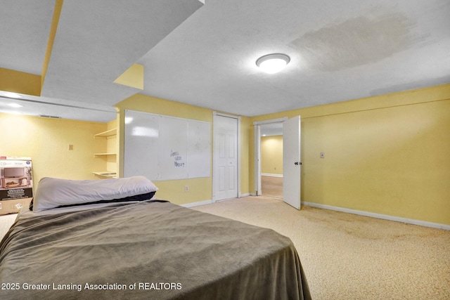 bedroom with baseboards, two closets, and carpet flooring