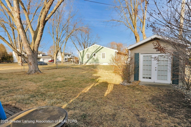 view of yard with an outdoor structure and fence