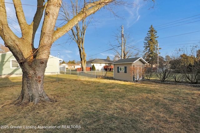 view of yard featuring an outdoor structure and fence