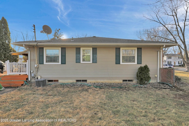 view of front of home with central AC and a front yard