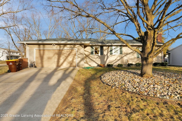 ranch-style home with brick siding, concrete driveway, and an attached garage