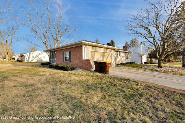 view of home's exterior with brick siding, concrete driveway, and a yard