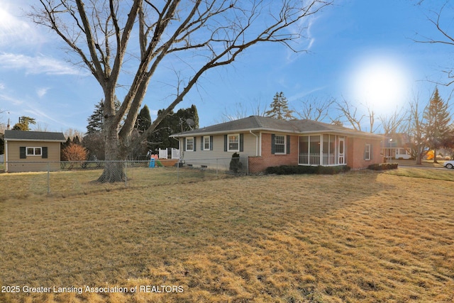 view of front of house featuring a front yard, fence, and brick siding