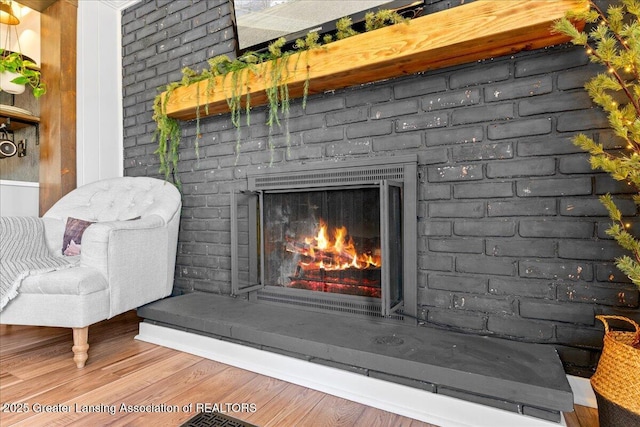 interior details featuring a fireplace and wood finished floors