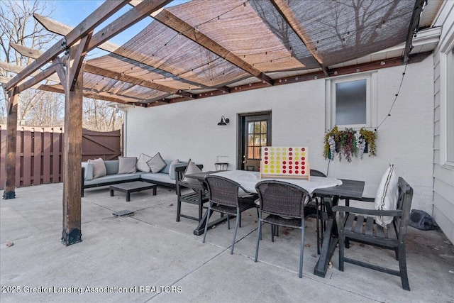 view of patio / terrace featuring outdoor dining space, fence, a pergola, and an outdoor hangout area