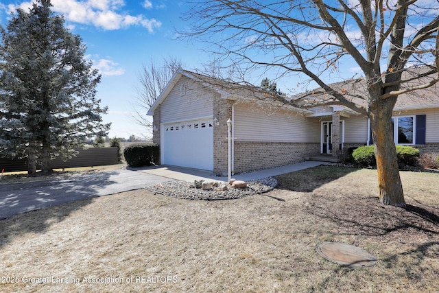 view of front of property with brick siding, concrete driveway, and an attached garage