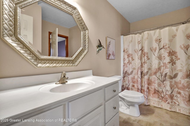 bathroom with vanity, a shower with shower curtain, and toilet