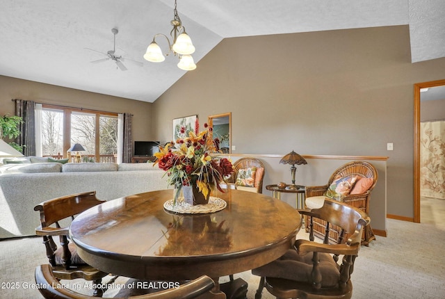 dining room with vaulted ceiling, ceiling fan with notable chandelier, baseboards, and light carpet