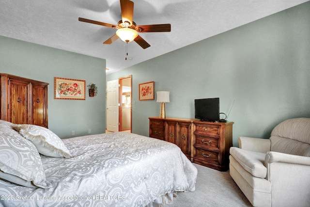 bedroom with light colored carpet and a ceiling fan