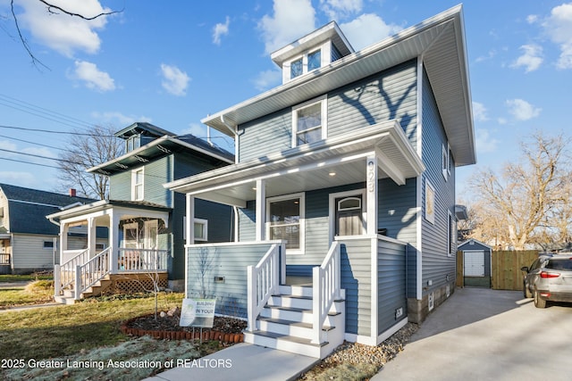 traditional style home featuring a porch and driveway