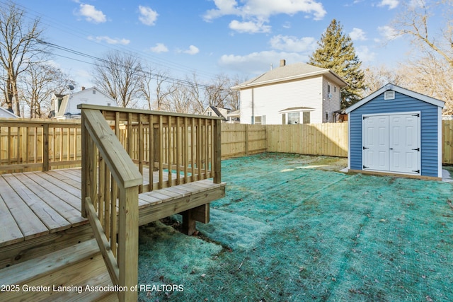 view of yard with an outdoor structure, a fenced backyard, a shed, and a wooden deck