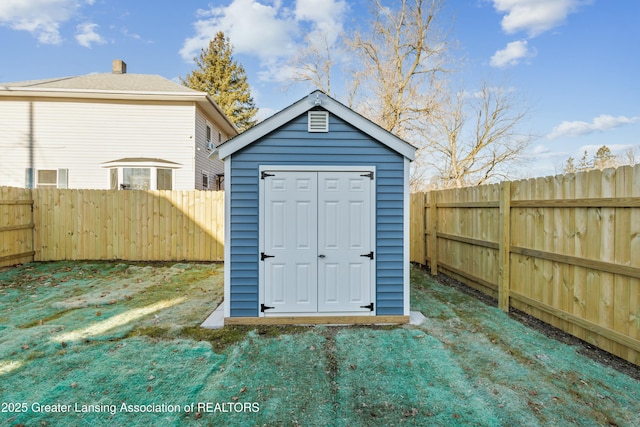 view of shed featuring a fenced backyard