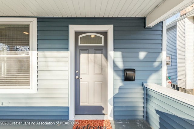 view of exterior entry with covered porch