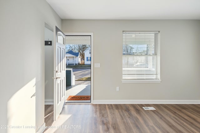 entryway featuring visible vents, wood finished floors, and baseboards